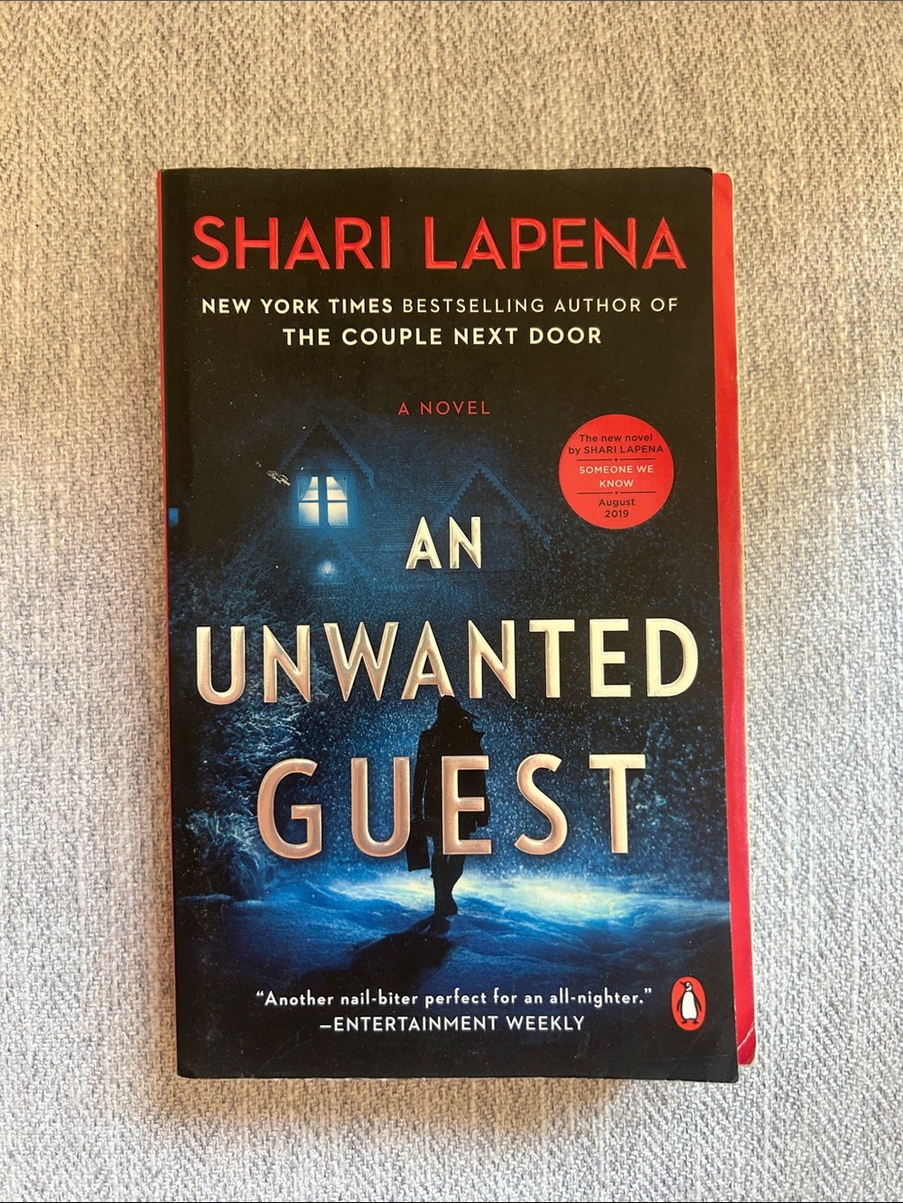 An Unwanted Guest by Shari Lapena - Blue & Black Paperback Thriller